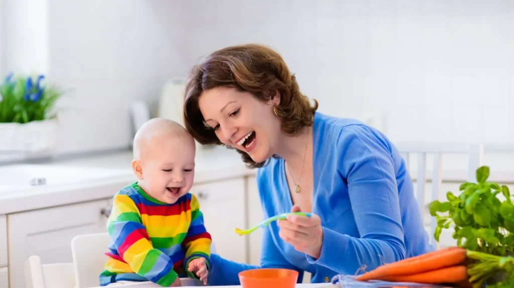 Top 20 Breastfeeding Tips for New Moms: Your Ultimate Guide to Success 8 A new mom feeding solid food to her baby