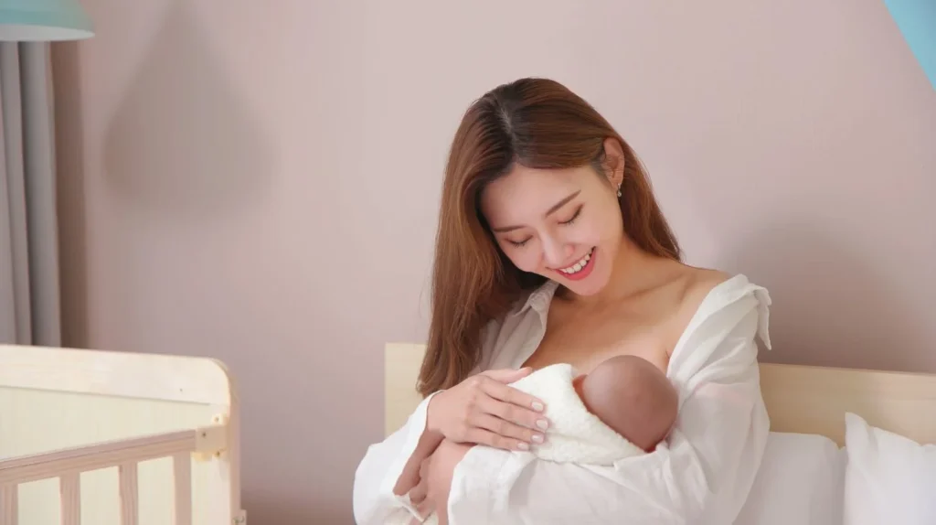 Top 20 Breastfeeding Tips for New Moms: Your Ultimate Guide to Success 5 A new mom holding her baby in a crib receives breastfeeding tips.
