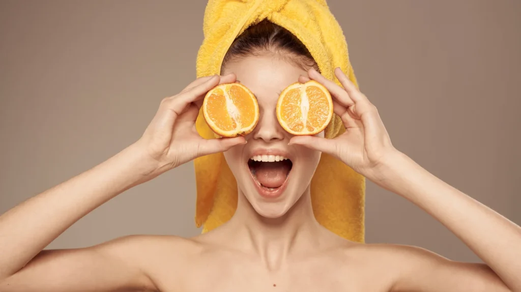 Top 20 Breastfeeding Tips for New Moms: Your Ultimate Guide to Success 9 A pregnant woman practicing safe beauty treatments by using orange slices to rejuvenate and soothe her eyes.