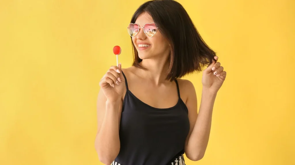 A woman is holding a sweet, one of the most common food cravings during pregnancy.